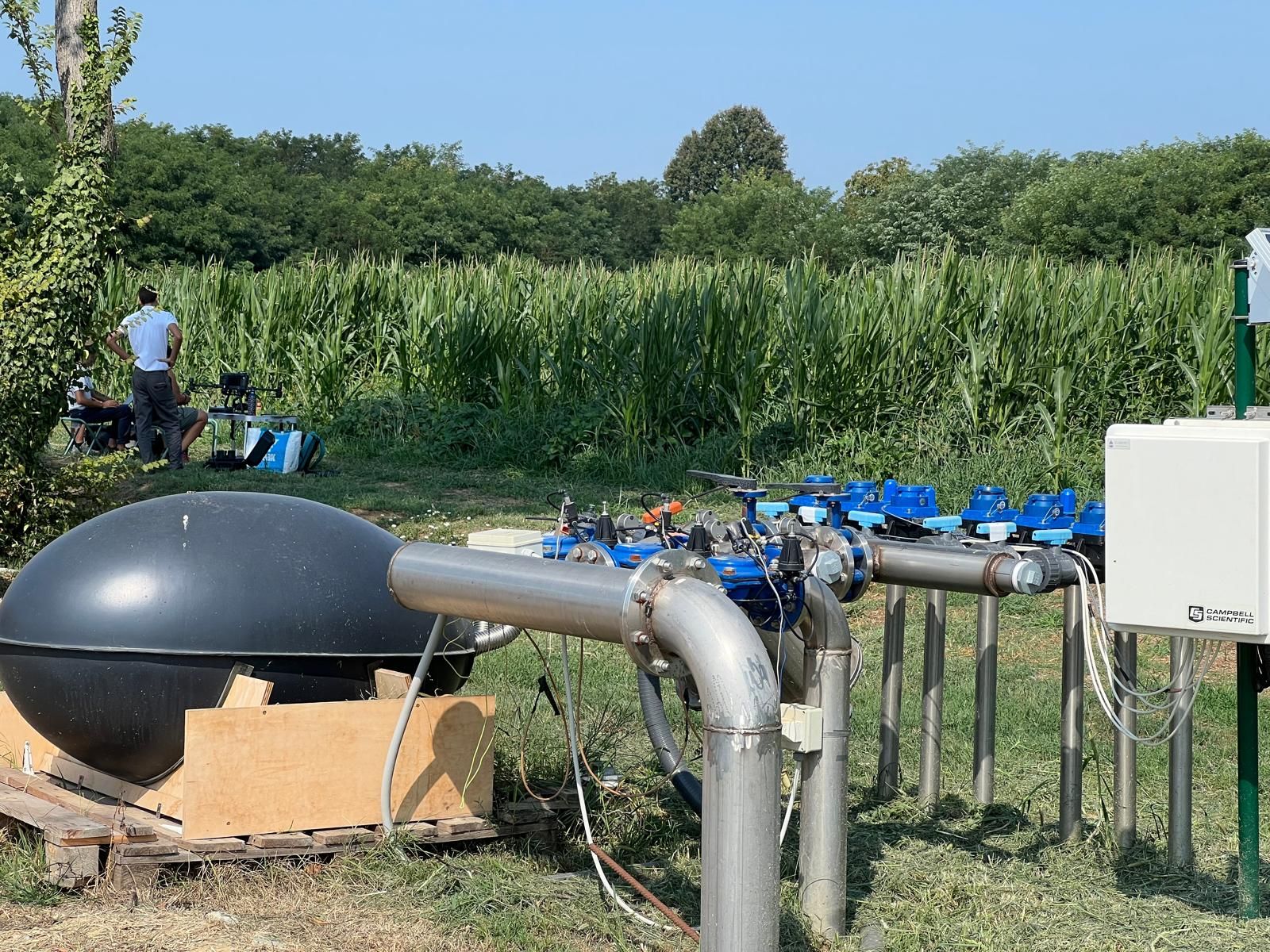 RNX NERO POWER® unit connected to an irrigation manifold in a maize field